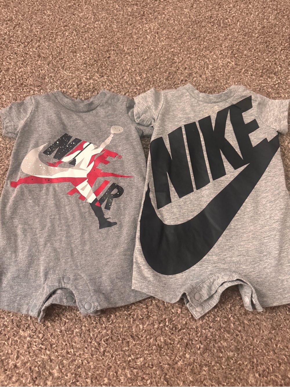 Two Nike Onesies